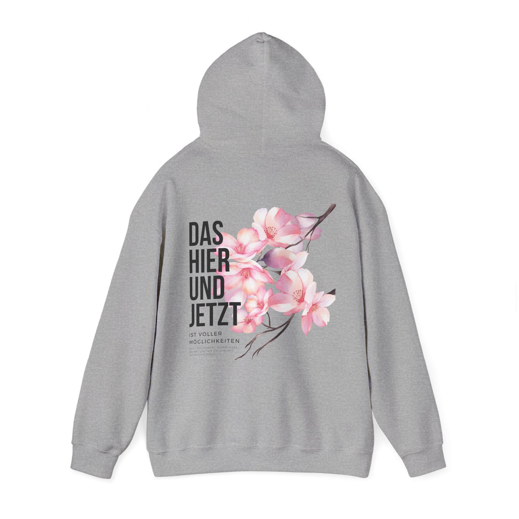 Unisex Hoodie mit Rückenprint „DAS HIER UND JETZT IST VOLLER MÖGLICHKEITEN“ – Hoodie mit inspirierender Botschaft