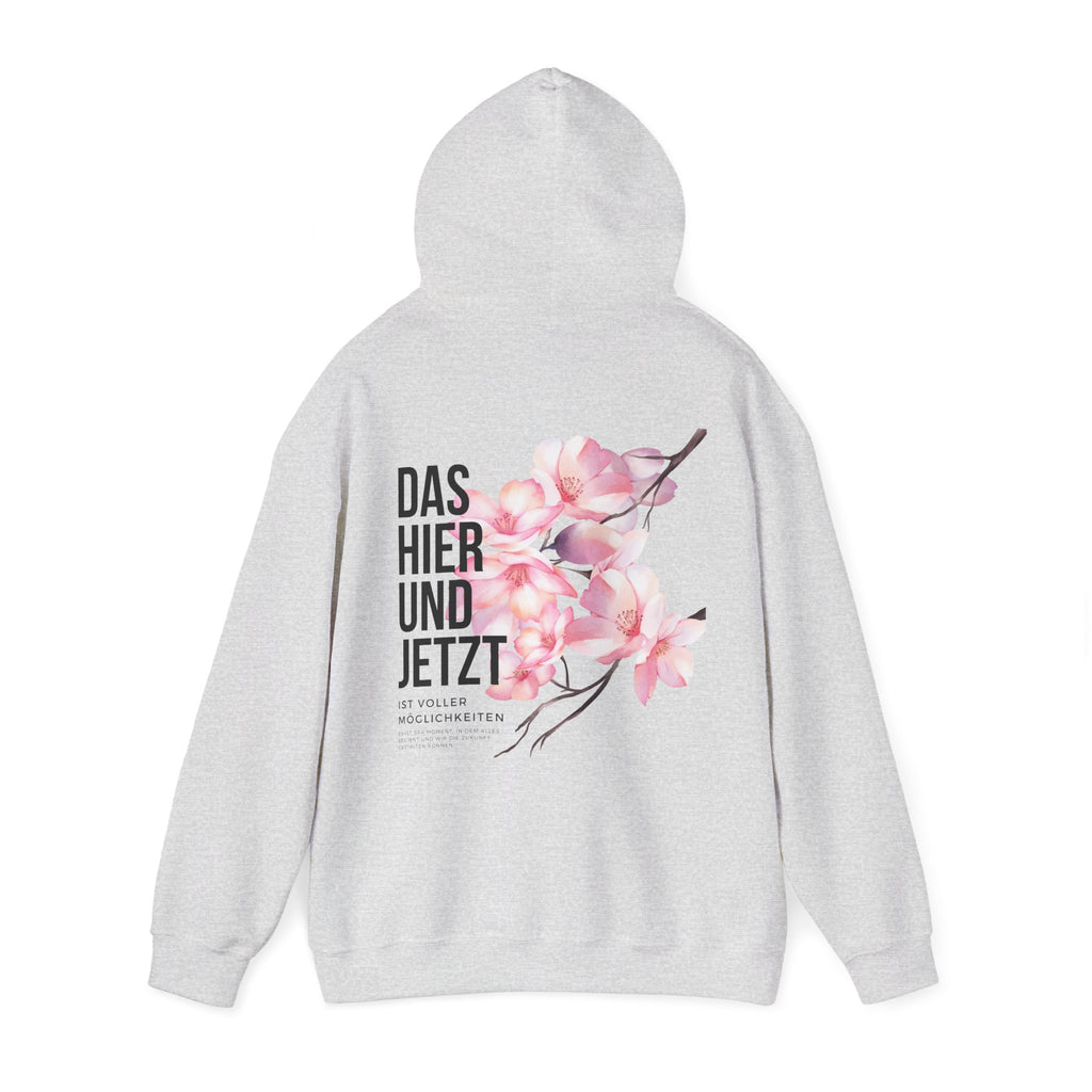 Unisex Hoodie mit Rückenprint „DAS HIER UND JETZT IST VOLLER MÖGLICHKEITEN“ – Hoodie mit inspirierender Botschaft